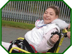 Student from Base1 enjoyinfg a ride on a specialy adapted bike